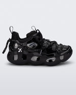 Side view of a black with grey accents Melissa X Icon sneaker