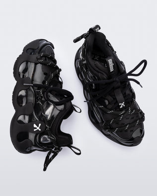 Side and top view of a pair of black with grey accents Melissa X Icon sneaker