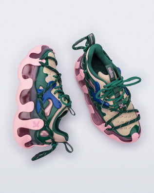 Side and top view of a pair of Melissa X Icon sneaker with pink sole and green and blue accents