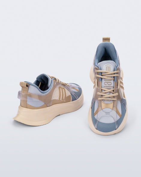 Top and back angled view of a pair of beige and gray Melissa X sneakers on a light gray background