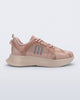 Side view of a Melissa X Beat pink and beige sneaker on a light gray background