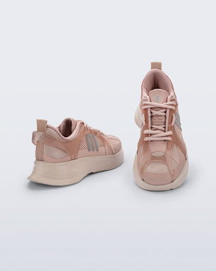 Back angle and top view of a pair of pink Melissa X Beat sneakers on a light gray background