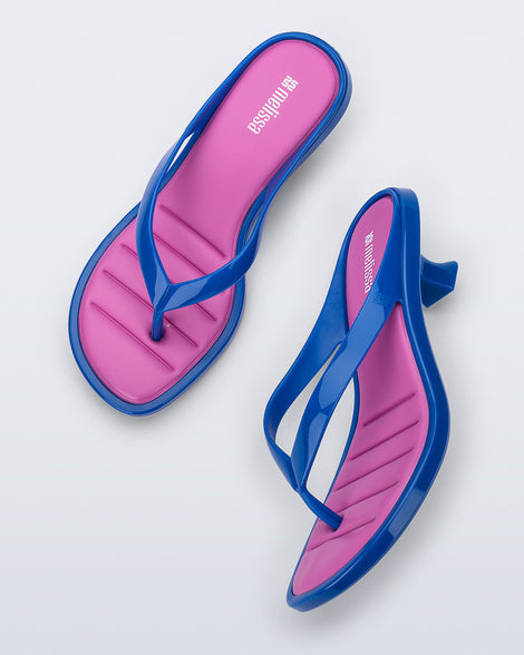 Top and side view of a pair of blue Flip Flop Kitten Heels with pink insole
