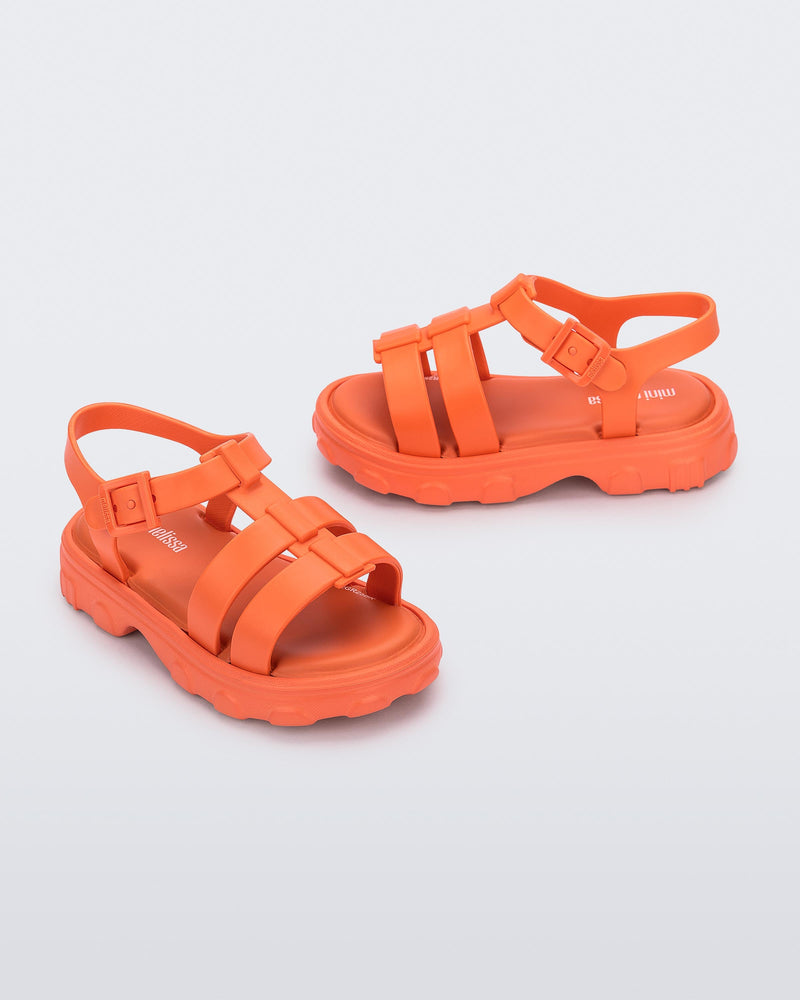 Side and angled view of a pair of orange Ella baby sandals