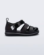 Side view of a black Smash closed toe baby sandal with grey trim