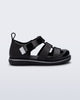 Side view of a black Smash closed toe baby sandal with grey trim
