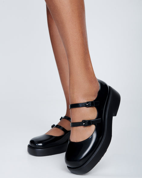 Model's legs wearing a pair of black Farah Low Mary jane loafers