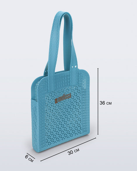 Angled view of a blue Harper bag with shoulder straps with bag measurements of 30cm x 6cm x 36cm