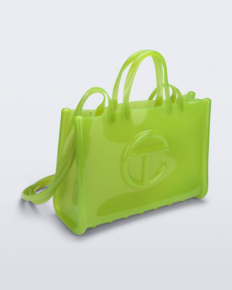 Angled view of the green Large Jelly Shopper x Telfar bag