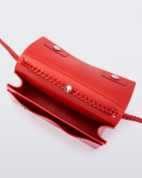 Inside view of the Melissa party handbag in red with main interior pocket and front small pocket