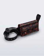 Angled view of a tortoise Cross Bag with adjustable black strap