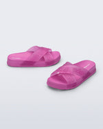 Side and angled view of a pair of pink Cozy M Lover Slides with Melissa on the upper