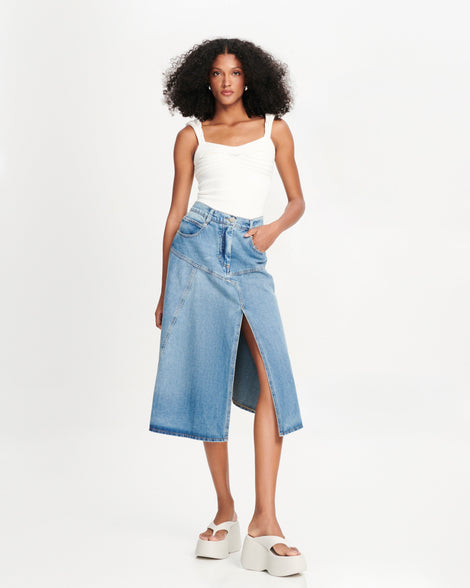 Model in a jean skirt and white tank wearing a pair of beige Free Thong  Wedge Platform heels