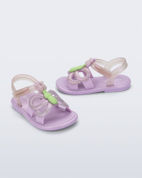 Side and angled view of a pair of lilac Hip Butterfly baby sandals