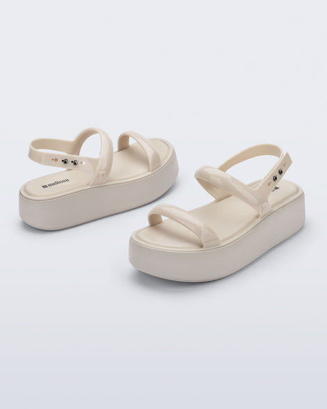 Back and angled view of a pair of beige Wave Platform sandals with top and heel straps