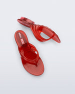 Top and side view of a pair of transparent red Flip Flop + Diesel sandals