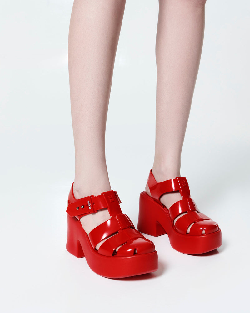 Model's legs in a pair of red Lulu platform heel fisherman sandals