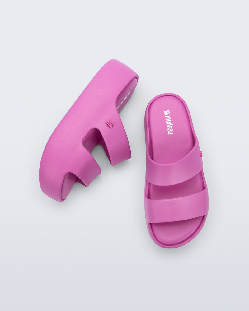 Top and side view of a pair of pink Free Line Platform slides