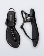 Top and Side view of a pair of black Solar Boho t-strap sandals with ,metallic detailing on the front strap