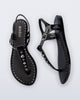 Top and Side view of a pair of black Solar Boho t-strap sandals with ,metallic detailing on the front strap