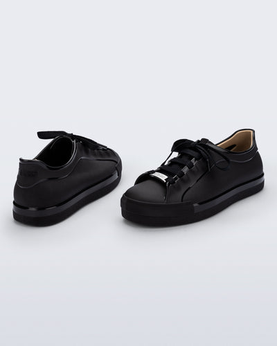 Back and angled view of a pair of black Wow Sneakers with black laces