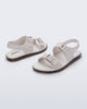 Side and angled view of a pair of beige Wave Sandals with two straps with buckles and a back strap
