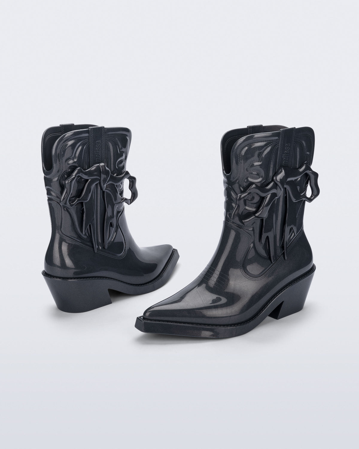 Front and back angled view pf a pair of metallic grey Texas + Maldito boots