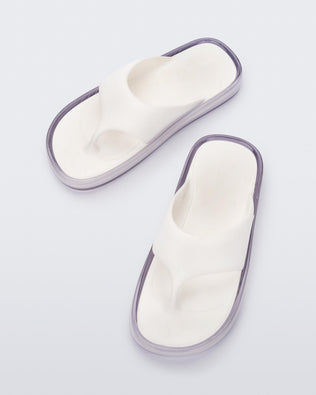 Top view of a pair of white with clear sole Float flip flops