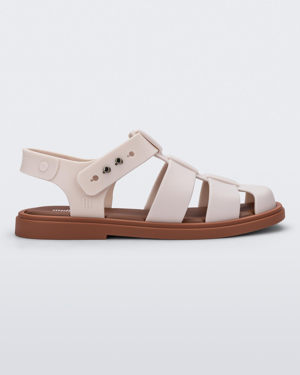 Side view of a beige Emma women's sandal with brown sole.