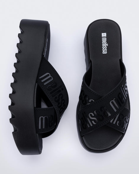 Top and side view of a pair of black M Lover Cross Strap platform slides