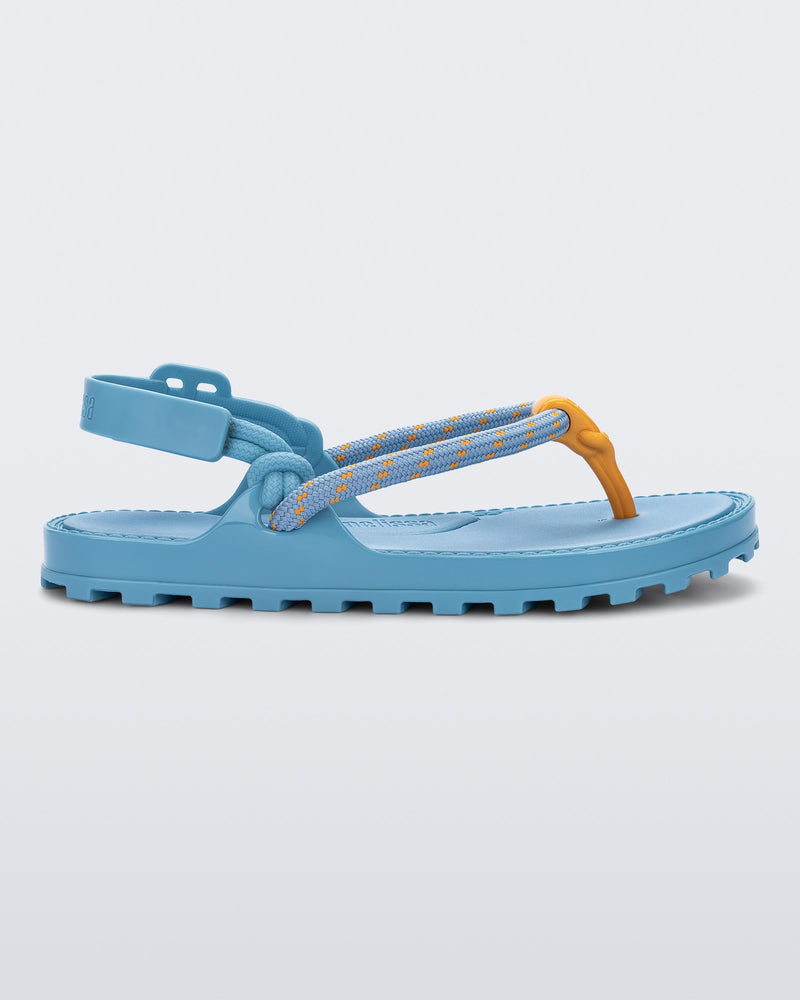 Side view of a blue Bond sandal with textile strap and orange toe piece