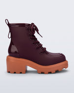 Side view of a burgundy Track Boot with small heel and burgundy laces and orange sole