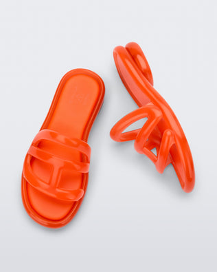 Top and side view of a pair of orange Jelly Slide x Telfar.