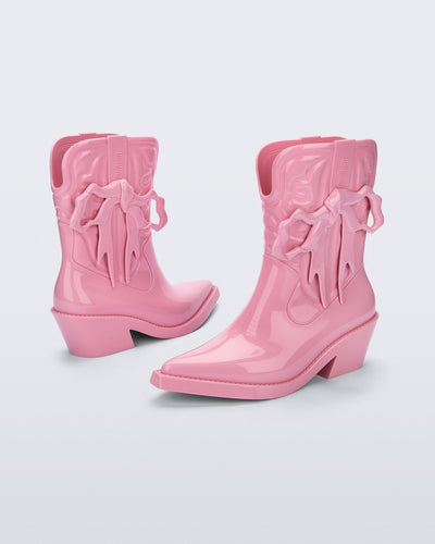 Front and back angled view pf a pair of pink Texas + Maldito boots