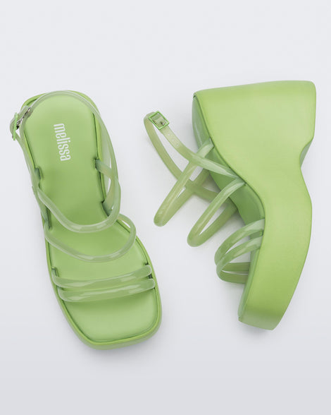 Side and top view of a pair of green Jessie platform wedge sandals with side buckle ankle strap