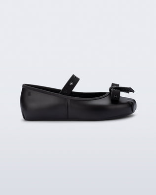Side view of a black Sophie Crush kids ballerina flat with bow