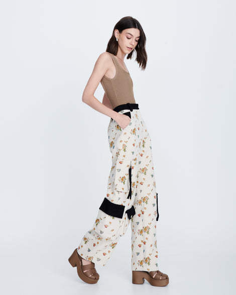 Model in a multicolor outfit wearing a pair of brown Lulu platform sandal.