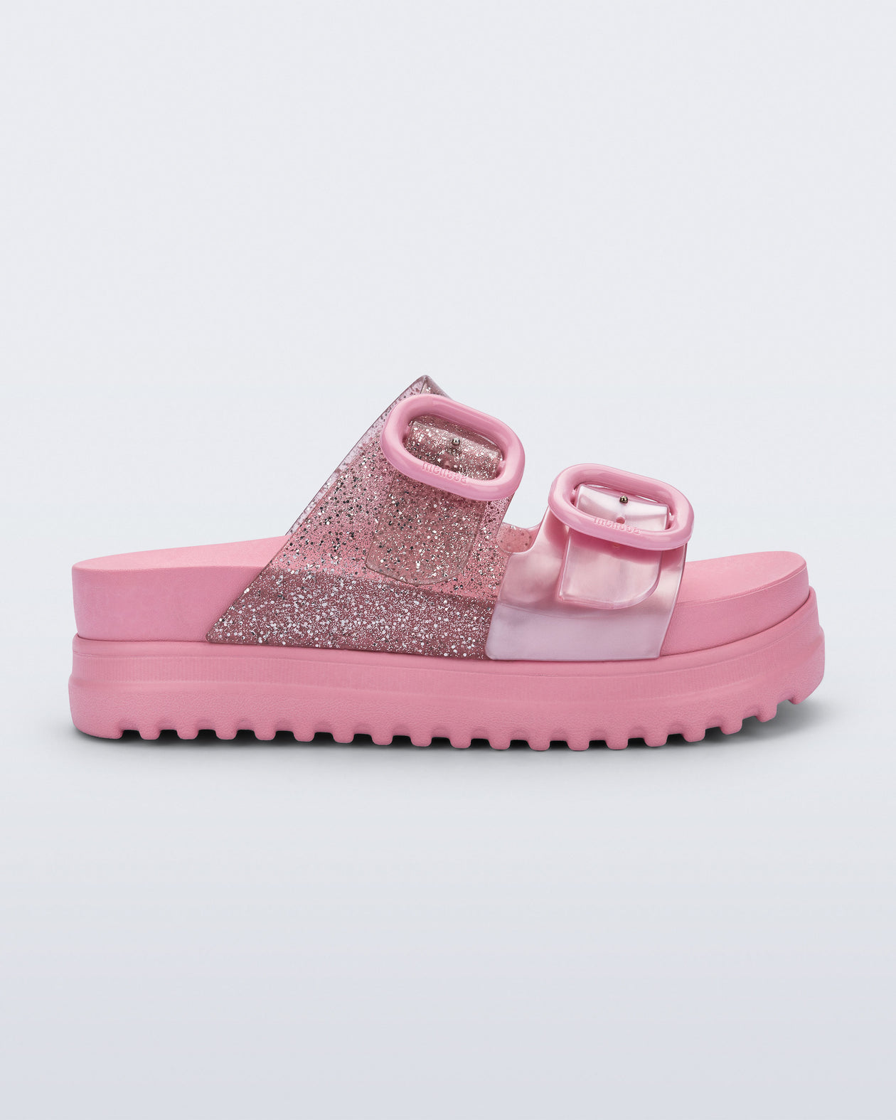 Side view of a pink Cozy Platform kids slide with two straps with buckles, one clear glitter the other pearly pink