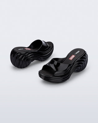 Back and side view of a pair of black Platforms + Diesel slides