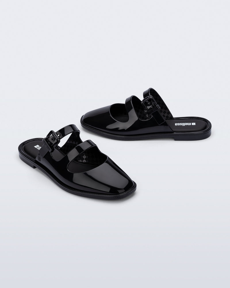 Side and angled view of a pair of black Anastasia mule slides