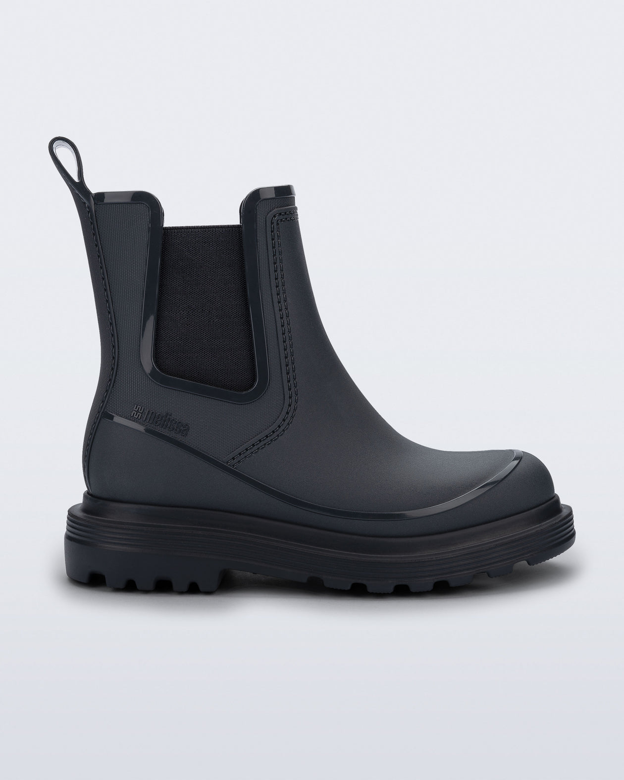 Side view of a grey Noir Boot with black sole