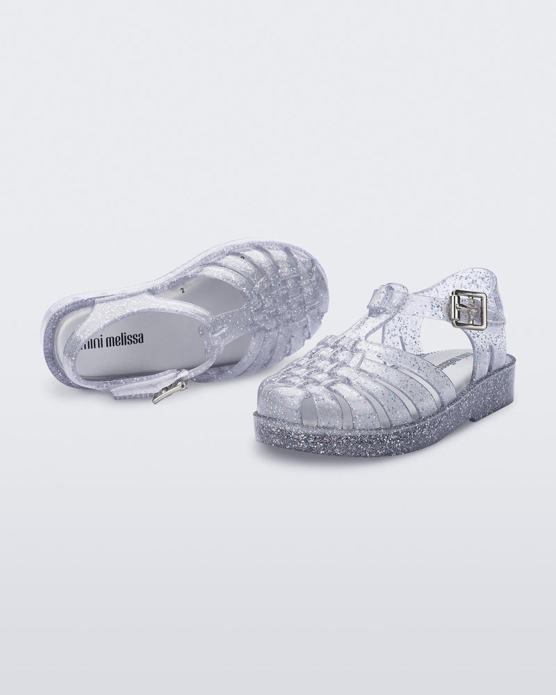 Top and side view of a pair of silver/glitter Possession babu fisherman sandals