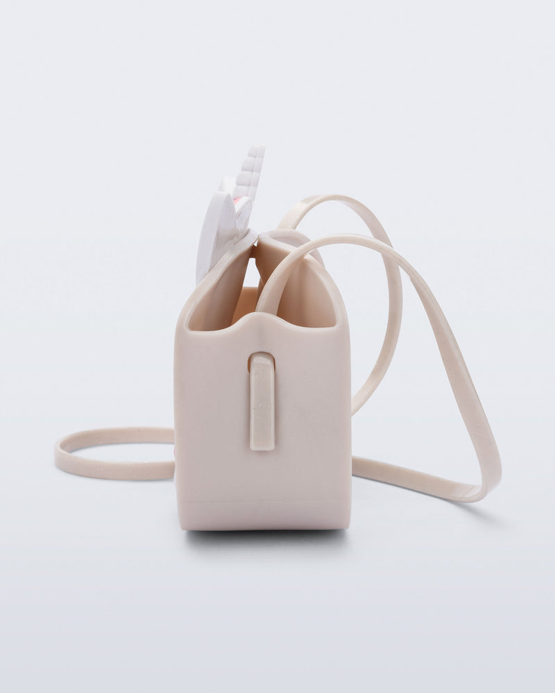 Side  view of a beige Dreamy Unicorn kids bag with a unicorn face on front with pink hair