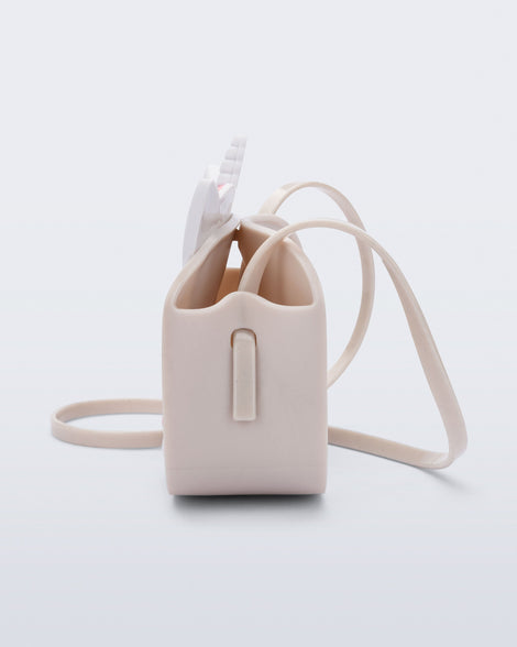 Side  view of a beige Dreamy Unicorn kids bag with a unicorn face on front with pink hair