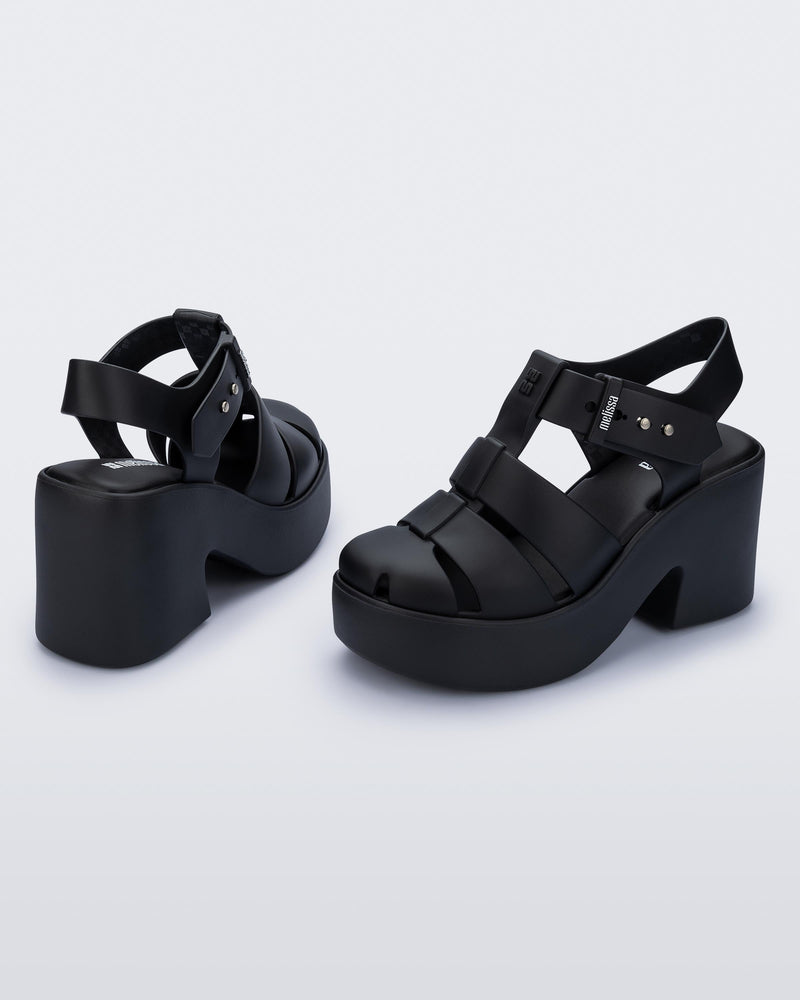 Back and angled view of a pair of matte black Lulu platform heel sandals