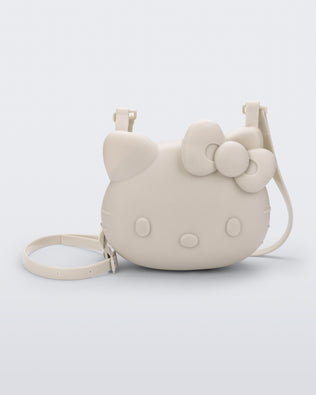 Front view of a beige Hello Kitty + Friends Cute Bag with the face of Hello Kitty