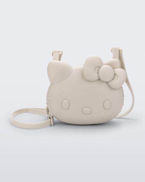 Front view of a beige Hello Kitty + Friends Cute Bag with the face of Hello Kitty