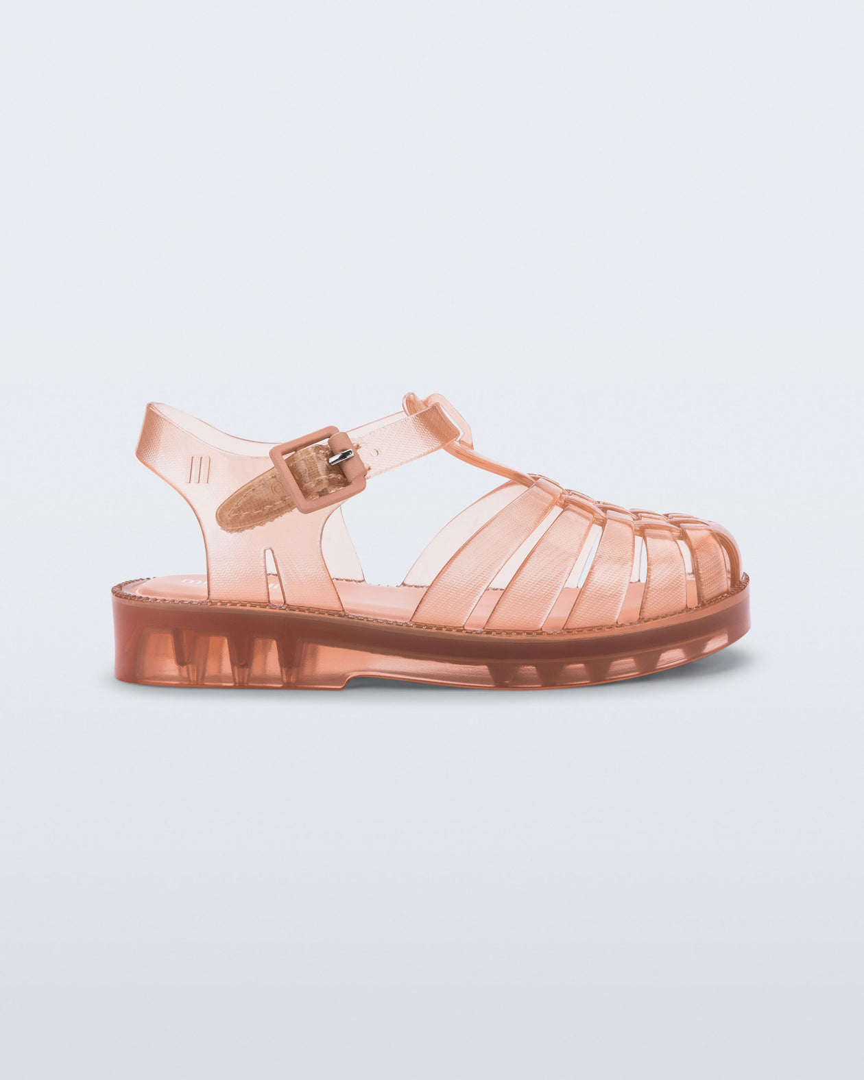 Side view of a clear beige/pink Possession baby sandal
