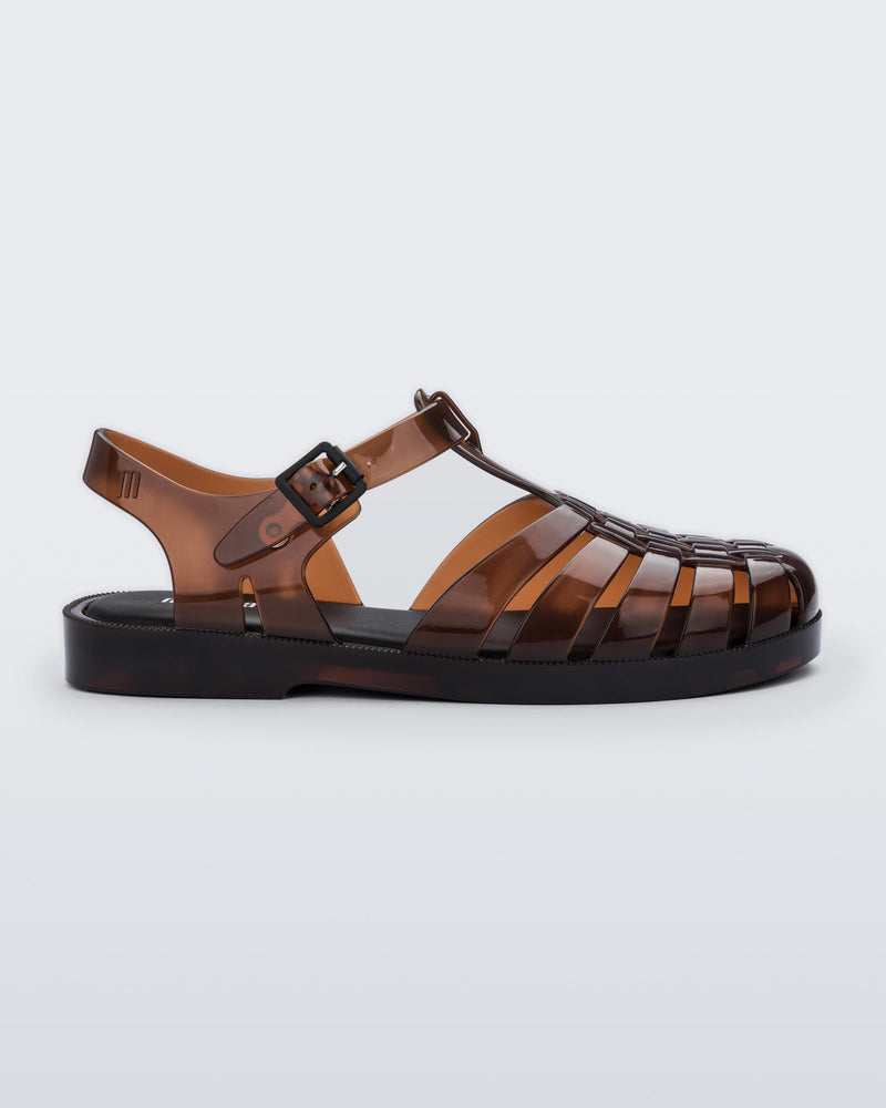 Side view of a clear brown Possession fisherman sandal