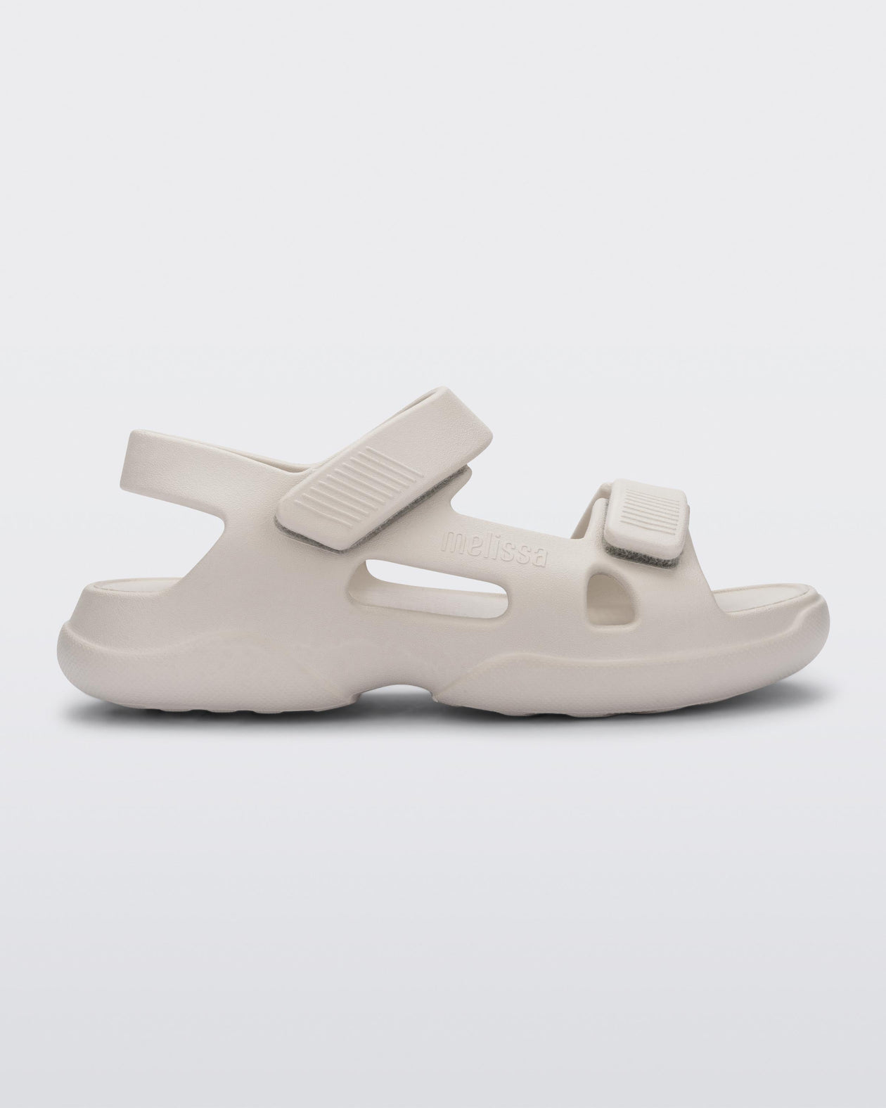 Side view of a beige Free Papete sandal